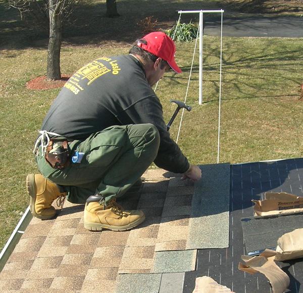 Owner Julius Laslo fixing a roof